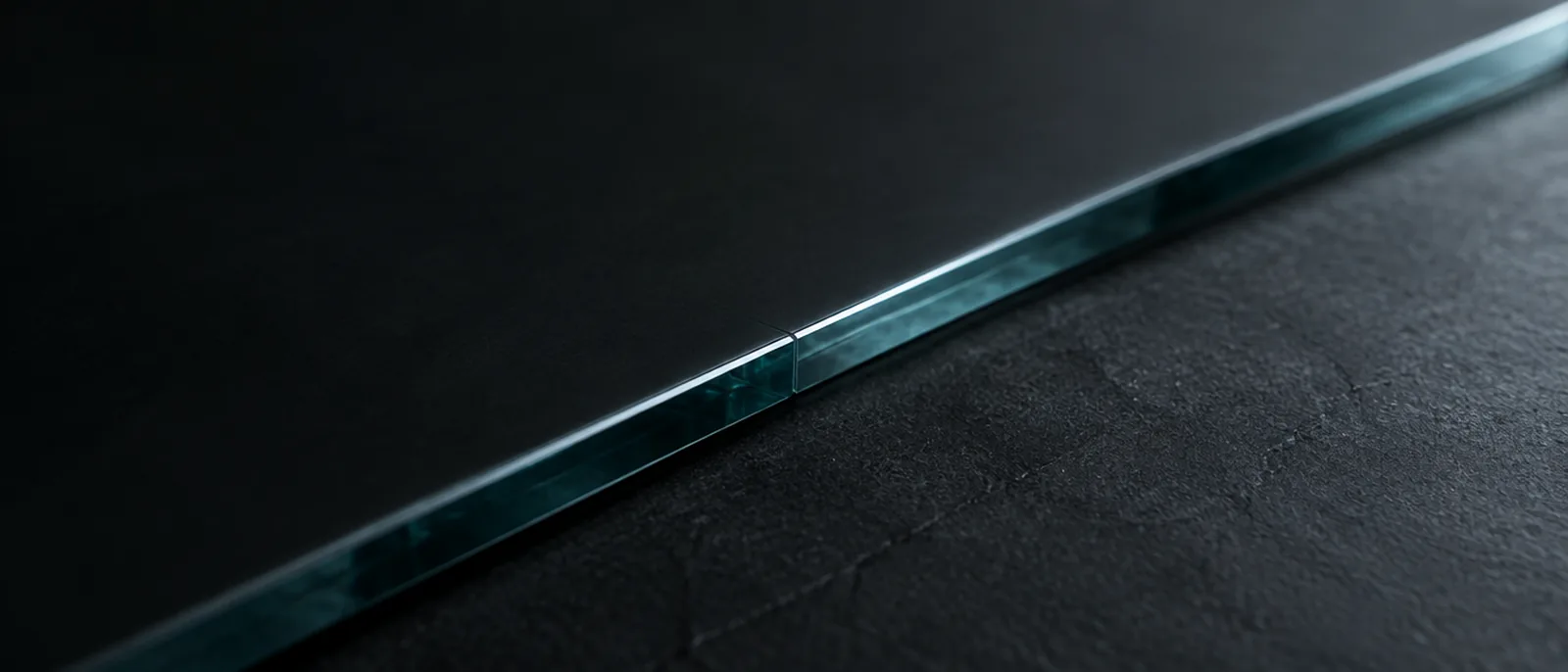 The lit seam between two sheets of dark glass.